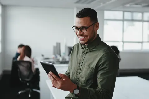 Man on his tablet in his office